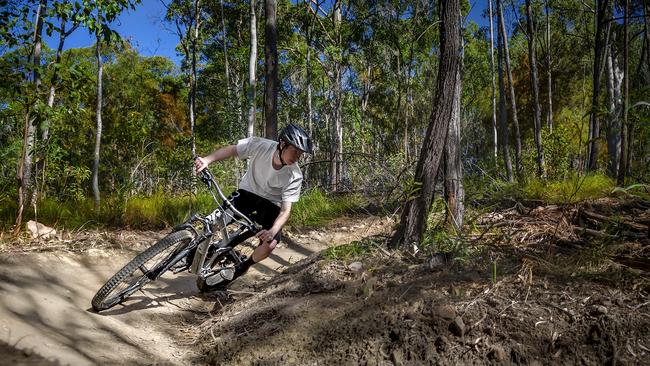 A mountain bike track rider takes a corner at the Reedy Creek tracks in the Glossy Black Cockatoo Reserve in the Gold Coast hinterland.