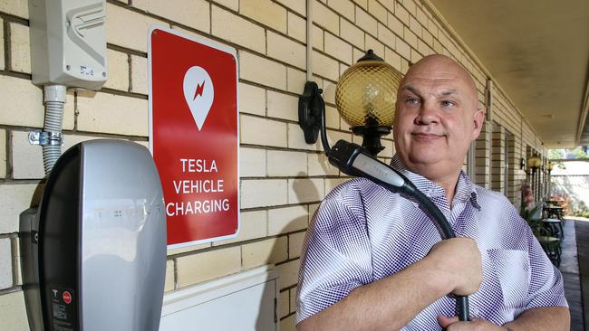 Nanango Star Motel owner Andrew Beck with newly installed Tesla vehicle charger. Photo: Dominic Elsome