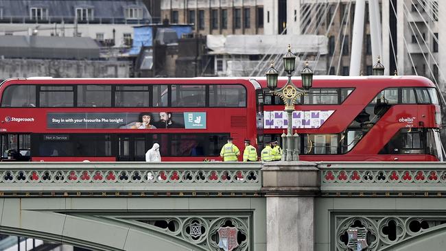 Police and forensic officers at the scene of a terrorist attack in which a number of pedestrians were mowed down on Westminster Bridge in London, England. Picture: Carl Court.