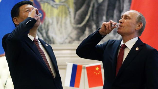 Chinese President Xi Jinping and President of Russia Vladimir Putin toast with vodka during a signing ceremony in China in 2014. Picture: Sasha Mordovets/Getty Images