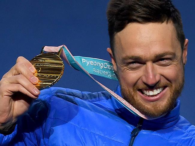 Supplied image of Australian SB-UL snowboarder Simon Patmore posing with his gold medal during the medal ceremony after winning the Men's Snowboard Cross - Upper Limb Impaired during day three of the PyeongChang 2018 Paralympic Games in PyeongChang, South Korea, Monday, March 12, 2018. (AAP Image/Australian Paralympic Committee, Sport The Library, Jeff Crow) NO ARCHIVING, EDITORIAL USE ONLY