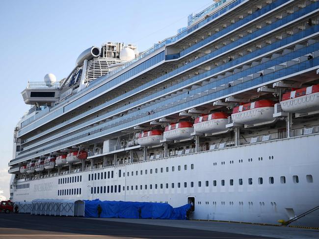 Military personnel set up a covered walkway (bottom) next to the Diamond Princess. Picture: Charly Triballeau