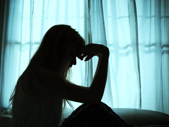 Silhouette of woman sitting in bed by window Picture: Istock