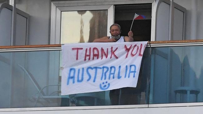 A crew member on the stricken ship says goodbye. Picture: Simon Bullard