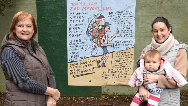 Zee Meyer with her daughter Renee Dowie and her grand daughter, Amelia, with the artwork where her husband Warren went missing in 2008. Picture: Lawrence Pinder