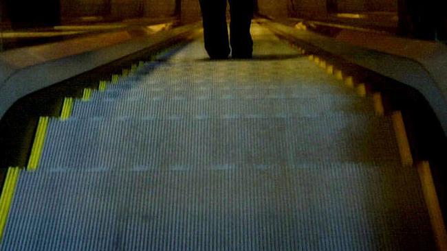 A Sydney woman was horrified to discover what a man was doing to her as she stood on an escalator.