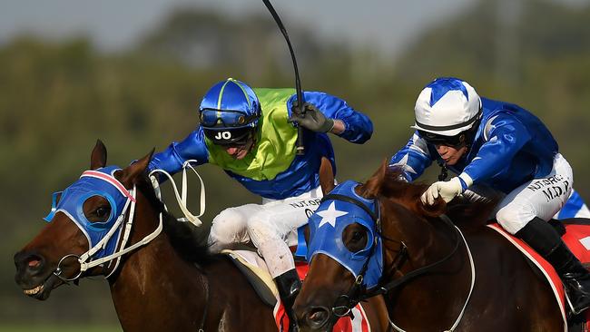 VICTOR: Jockey James Orman rides Tycoon Ace, left, to victory in the Swiss Ace Plate at the Sunshine Coast on Saturday. Picture: AAP Image/Albert Perez.