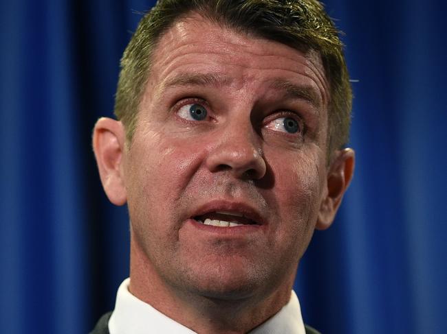 NSW Premier Mike Baird and Deputy Premier Troy Grant, (left), speak to the media in Sydney, Tuesday, Oct. 11, 2016. NSW Premier Mike Baird has performed an extraordinary backflip on his greyhound racing ban after yielding to sustained industry and media pressure, saying "he got it wrong". (AAP Image/Dan Himbrechts) NO ARCHIVING