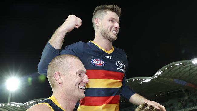 Bryce Gibbs gets chaired off in his 250th game by Sam Jacobs and Rory Sloane. Picture SARAH REED