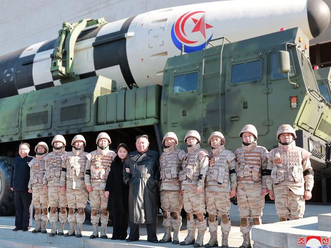 Kim Jong-un and his daughter pose alongside soldiers with the new ICBM in the background. Picture: KCNA VIA KNS / AFP.