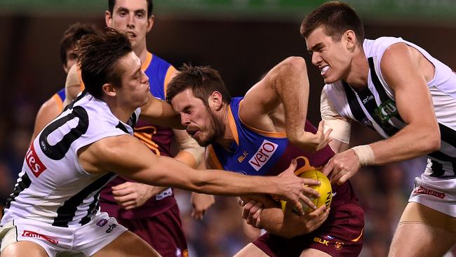 Brisbane midfielder Ryan Bastinac under pressure from Darcy Moore and Mason Cox. Picture: AAP
