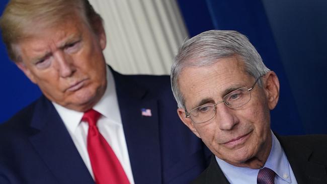 Donald Trump called Dr Anthony Fauci, right, an alarmist when he said coronavirus would get out of control. Picture: AFP