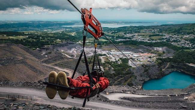 A brave visitor takes Zip World's Velocity 2 Zip Line through Penhyrn Quarry, North Wales. Picture: VisitWales