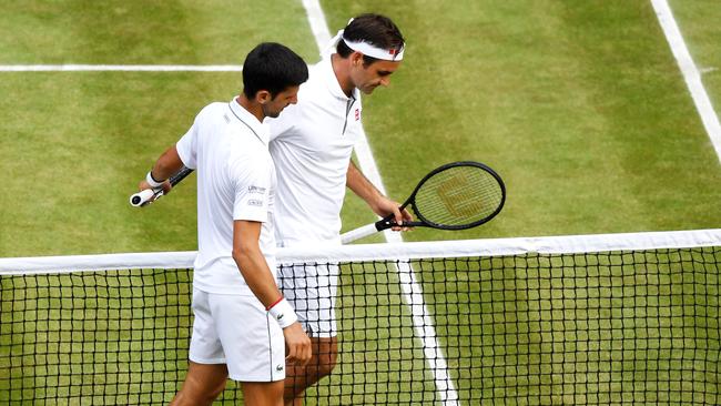 Novak Djokovic embraces Roger Federer at the net following his victory in the 2019 Wimbledon final. Picture: Getty Images