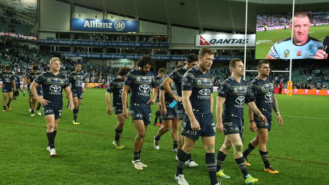 History to repeat? Dejected North Queensland Cowboys leave the field as a smiling Paul Gallen is interviewed on the screen after the 2016 preliminary final.