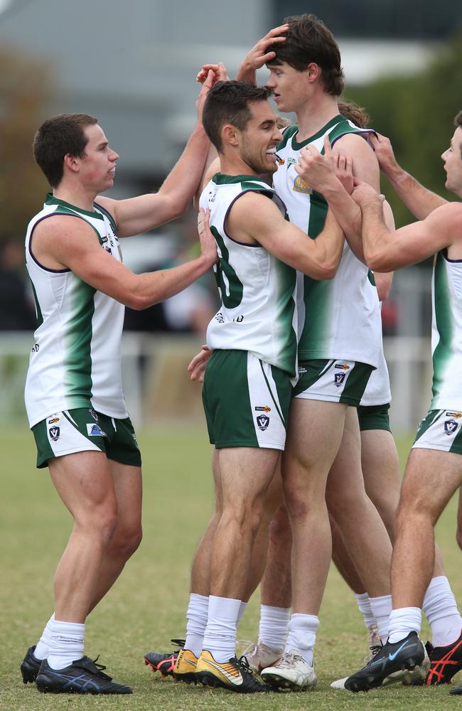 Bell Park’s Will Christie kicks a goal and celebrates with teammates. Picture: Mark Wilson