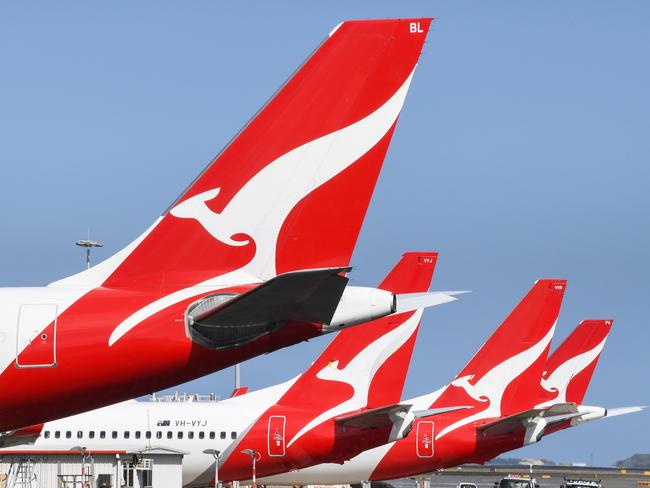 SYDNEY, AUSTRALIA - AUGUST 18: The tail fins of Qantas aircraft parked at Sydney's Kingsford Smith International Airport on August 18, 2021 in Sydney, Australia. Qantas Group has announced COVID-19 vaccinations will be mandatory for all 22,000 staff members. Frontline employees Ã¢â¬â including cabin crew, pilots and airport workers Ã¢â¬â will need to be fully vaccinated by November 15 and the remainder of employees by March 31. There will be exemptions for those who are unable to be vaccinated for documented medical reasons, which is expected to be very rare. (Photo by James D. Morgan/Getty Images)