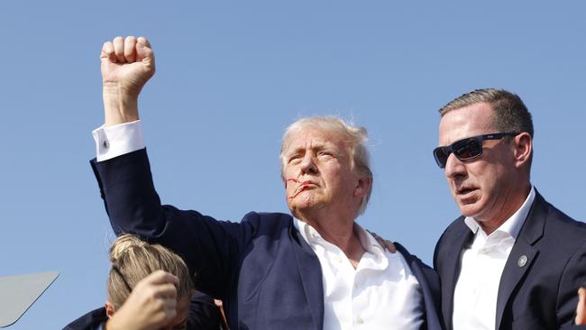 … then stands to raise a fist to the crowd … Picture: Getty Images via AFP