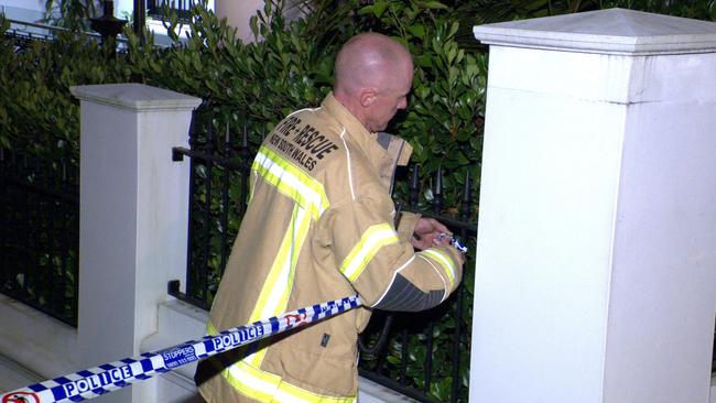 A firefighter cordons off the scene after the fire was extinguished. Picture: OnScene Bondi