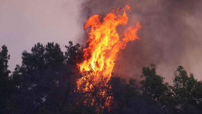 Flames shoot upward from a burning house as the Palisades Fire grows. Picture: David Swanson / AFP