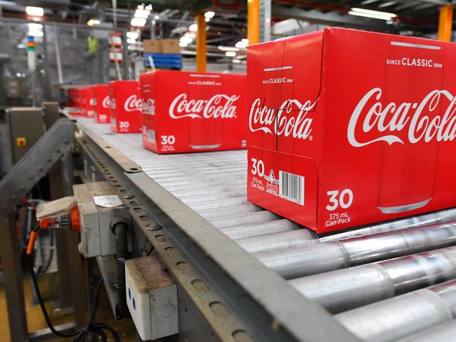 Boxes of coke are seen on the production line at the Coca Cola factory in Melbourne, Tuesday, February 25, 2020. Andrews has announced a $96.5mil package to improve Victoria's recycling industry. (AAP Image/James Ross) NO ARCHIVING