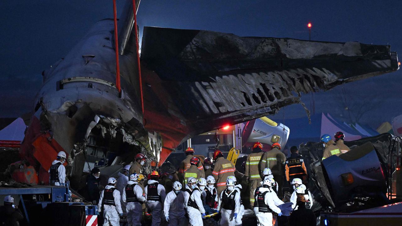 Firefighters and rescue personnel work at the scene. Picture: Jung Yeon-je / AFP