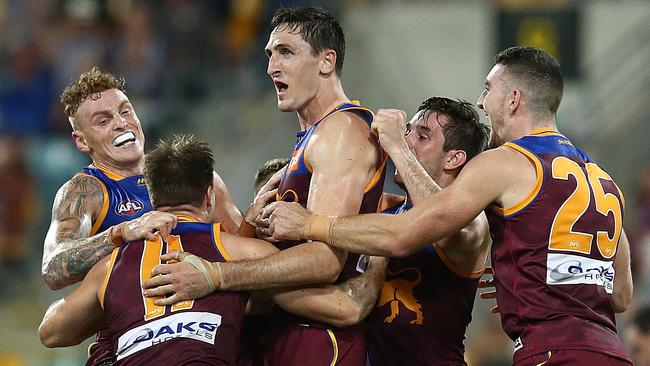 Oscar McInerney stands head and shoulders above his teammates after kicking a goal during the Lions win over Port Adelaide. Picture: Jono Searle/AFL Photos/Getty Images. 