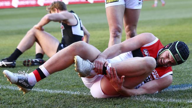 Paddy McCartin clutches at his ankle after colliding with Tom Jonas during the Saints’ Round 16 clash with Port Adelaide. Picture Sarah Reed