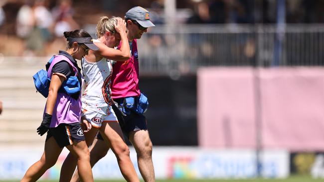 Giant Annalyse Lister is assisted from the ground by the club doctor and trainer in Round 1. Picture: Paul Kane/Getty Images