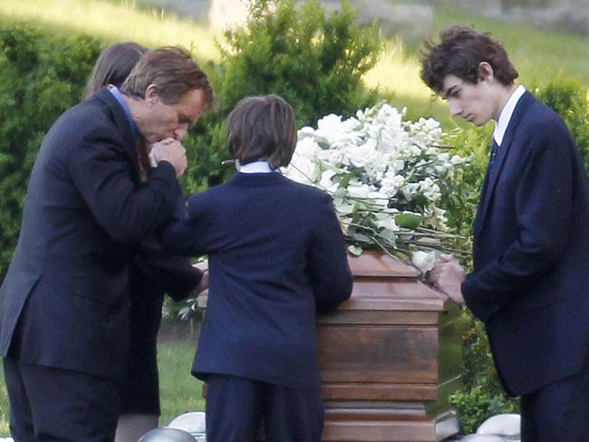 Robert F. Kennedy Jr kneels with his children at the funeral off Mary Richardson Kennedy in 2012. Picture: AP