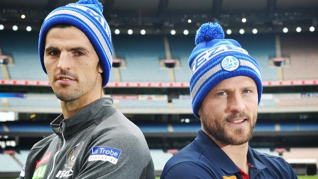 Collingwood captain Scott Pendlebury and Melbourne skipper Nathan Jones pose in beanies in support of the FightMND campaign. Picture: AAP.