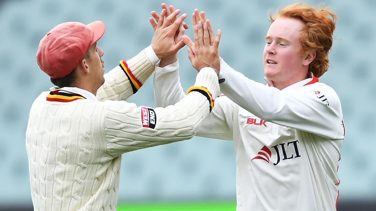 Lloyd Pope (R) celebrates after taking a wicket in the Sheffield Shield.