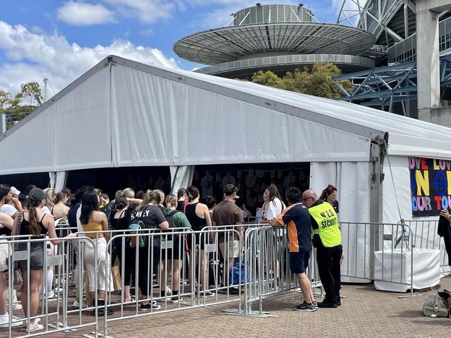 Fans outside Accor stadium buying Harry Styles merchandise the day before his first Sydney concert.