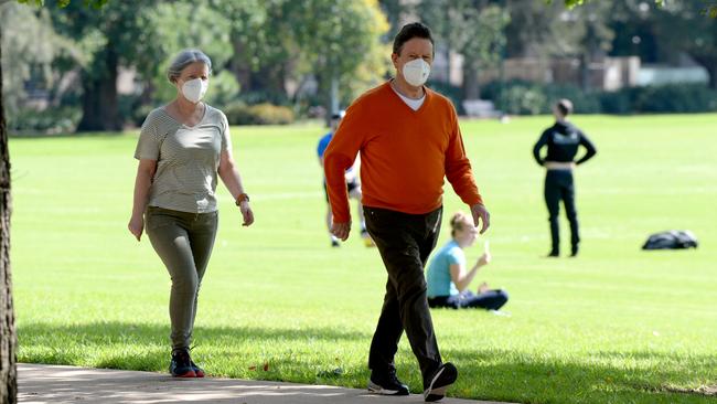 People wear masks while getting some exercise at Fawkner Park. Picture: Andrew Henshaw