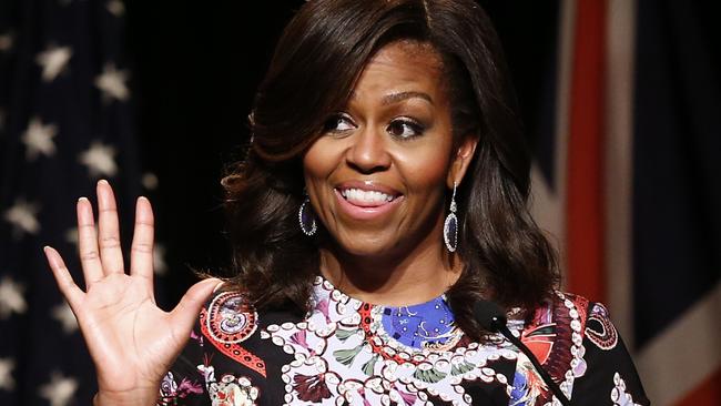 US First Lady Michelle Obama gives an address during a visit as part of the US government's 'Let Girls Learn' initiative at Mulberry School for Girls in east London on June 16, 2015. On the first full day of a visit to Britain the US First Lady met with local students in east London and discussed how Britain and the US are working together in order to attempt to expand access to adolescent girls' education around the world. While in London, the First Lady will also host a roundtable meeting on Let Girls Learn, and meet with British Prime Minister Cameron, Samatha Cameron, and Prince Harry. AFP PHOTO / JUSTIN TALLIS