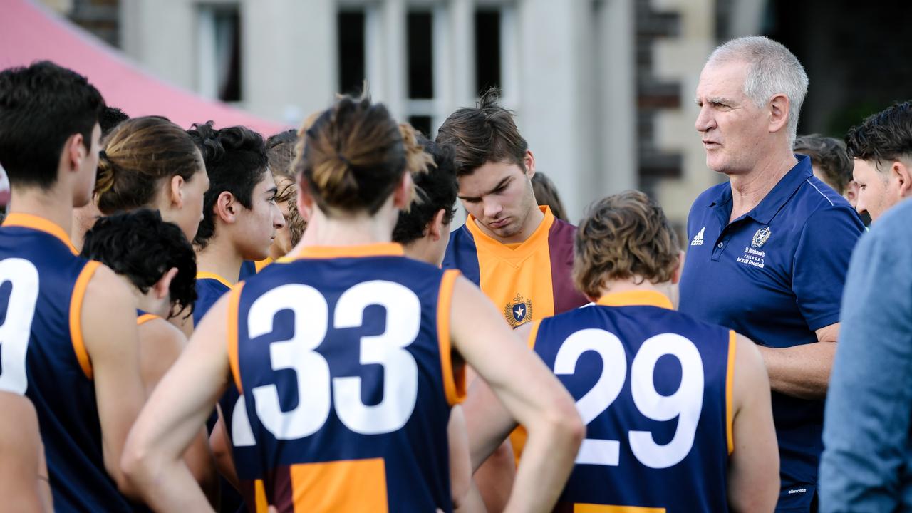 Mark Mickan talking to St Michael's players at the quarter-time huddle in Adelaide, Saturday, May 5, 2018.  (AAP Image/Morgan Sette)