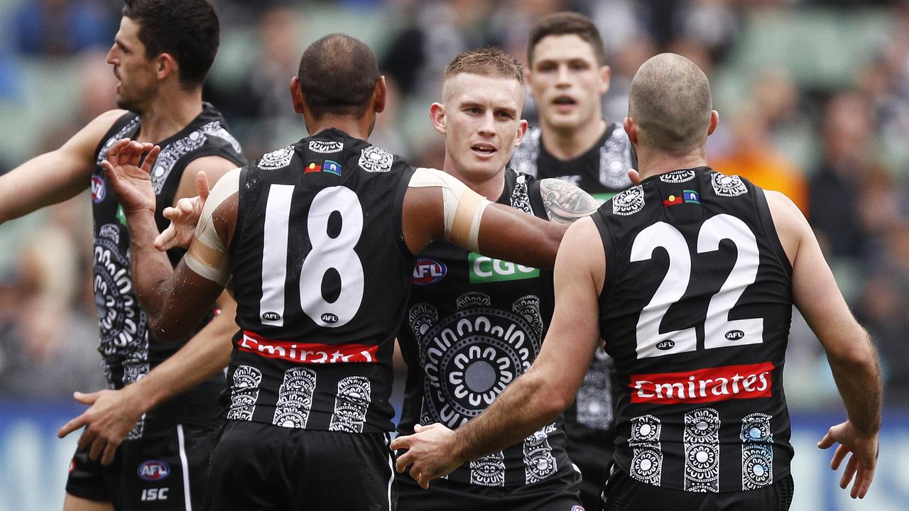 Dayne Beams of the Magpies (centre) has confirmed his retirement.