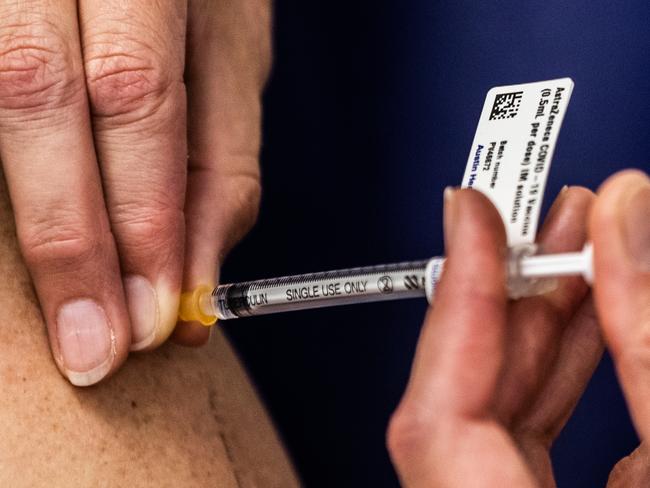 MELBOURNE, AUSTRALIA - MARCH 17: A nurse administers the AstraZeneca COVID-19 vaccine to a patient at the Austin Hospital on March 17, 2021 in Melbourne, Australia.  An online system has opened for phase 1B of the Australian COVID-19 vaccination program which includes people over aged 70, frontline workers, and individuals with certain medical conditions. Over 1000 general practitioners are participating in the vaccination program. (Photo by Asanka Ratnayake/Getty Images)