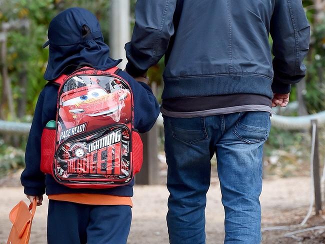 Parents walk their children into the scool grounds.  Vox Pop with parents on the planned injection room in Lennox street Richmond next to Richmond West Primary School.  .  Picture: Nicole Garmston
