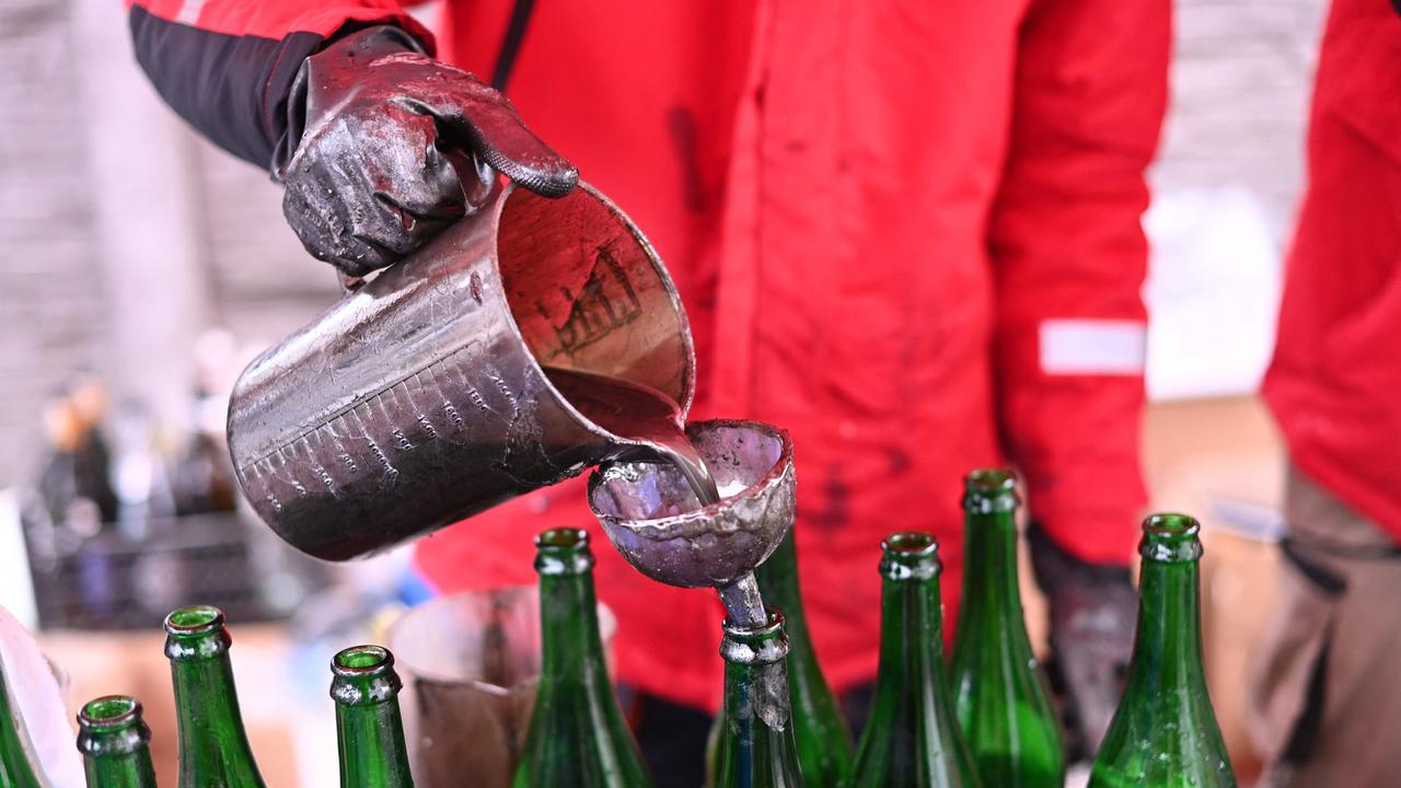 A volunteer demonstrates the preparation of Molotov cocktails at the Pravda