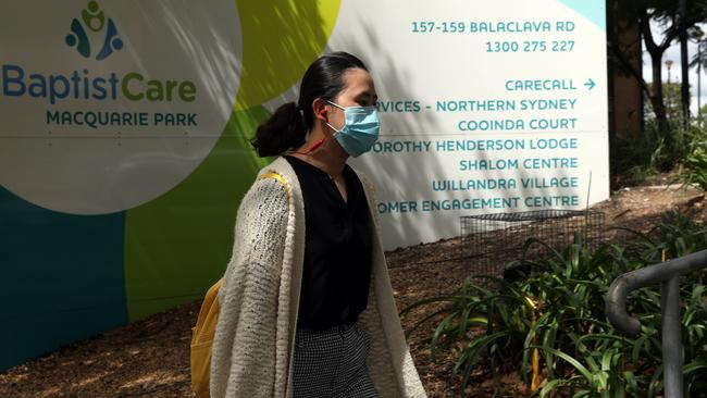 A woman walks past the Dorothy Henderson Lodge in Marsfield in the early days of the pandemic when the facility suffered a deadly COVID-19 outbreak. Picture: Jane Dempster/The Australian.