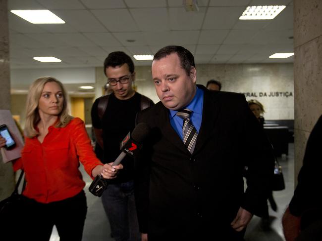 Mauricio Eduardo Mayr, centre, is the lawyer representing Marcelo Ferreira dos Santos Santoro. Picture: AP Photo/Silvia Izquierdo