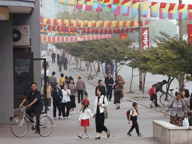 Pyongyang citizens go about their normal daily life in the capital after the nuclear test by their government in 2006.