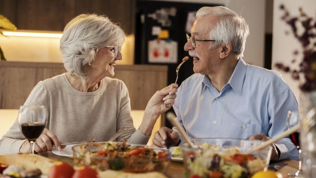 A couple cooking and eating dinner at home. Probably at around 5pm. Picture: istock