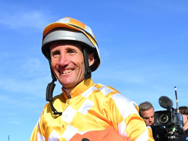 MELBOURNE, AUSTRALIA - NOVEMBER 18: Damien Oliver is congratulated by wife Trish Oliver after his last ride riding Queen of the Ball after Race 10 , the Neds How Now Stakes, during Melbourne Racing at Caulfield Racecourse on November 18, 2023 in Melbourne, Australia. (Photo by Vince Caligiuri/Getty Images)