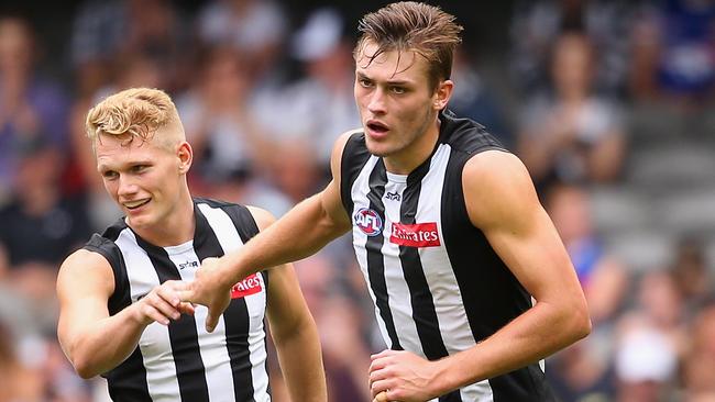 MELBOURNE, AUSTRALIA - MARCH 12: Adam Treloar of the Magpies congratulates Darcy Moore after he kickied a goal during the 2016 NAB Challenge AFL match between the Collingwood Magpies and the Western Bulldogs at Etihad Stadium on March 12, 2016 in Melbourne, Australia. (Photo by Quinn Rooney/Getty Images)