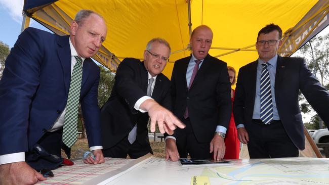 January announcement: Looking over maps showing road upgrades for Bracken Ridge are Member for Petrie Luke Howarth, Prime Minister Scott Morrison, Member for Dickson Peter Dutton, and Federal Minister for Cities, Urban Infrastructure and Population Alan Tudge. Picture: Annette Dew