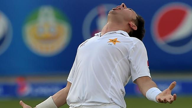Pakistani spinner Yasir Shah celebrates after taking the wicket of West Indies batsman Miguel Cummins.