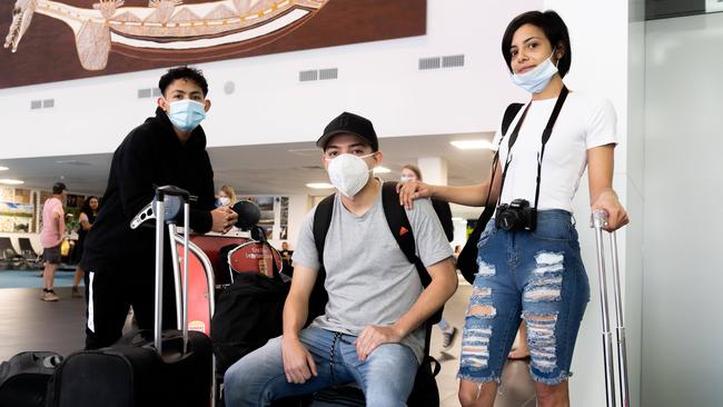 Rafael Soares das Neves, 18, Tyronne Soares das Neves 20, and Marina Soares 25, were on board a flight that arrived in Darwin today after travelling through NSW from Melbourne. Picture: Che Chorley