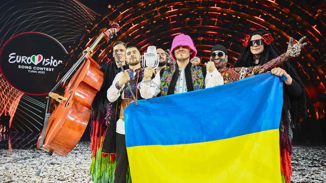 Members of the band "Kalush Orchestra" pose onstage with the winner's trophy and Ukraine's flags after winning on behalf of Ukraine the Eurovision Song contest 2022.